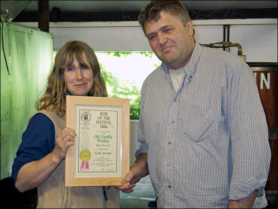 Boss and wife with award