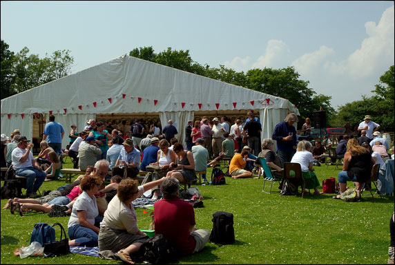 On the grass outside the beer tent